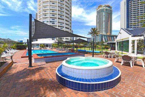 a swimming pool with a fountain in the middle of a building at Focus OCEAN VIEW in Gold Coast