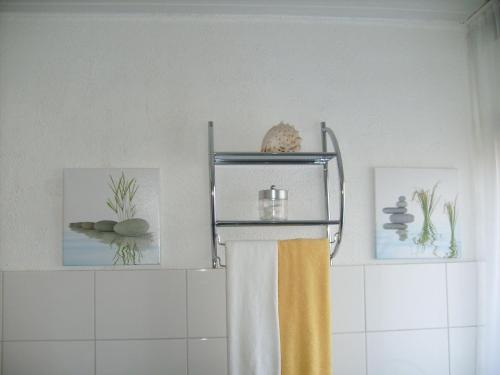 a towel rack in a bathroom with a shower curtain at Apartment Adam in Bechenheim