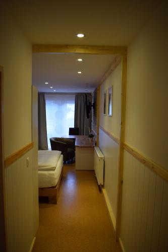 a hallway with a room with a bed and a couch at Apartmenthaus Erlenbach in Erlenbach