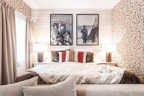 a bedroom with a large bed with two lamps at Arctic Light Hotel in Rovaniemi