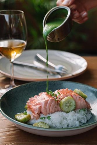a plate of food with a piece of salmon and rice at Urban Boutique Hotel in Tbilisi City