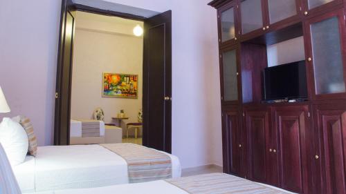 Кровать или кровати в номере Hotel Lavanda CAS Merida