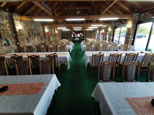 a row of tables and chairs in a restaurant at Etno selo EDEN in Žeravački Potok