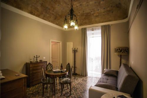 a living room with a couch and a table at La Dimora del Falconiere - Luxury Suites in Sulmona