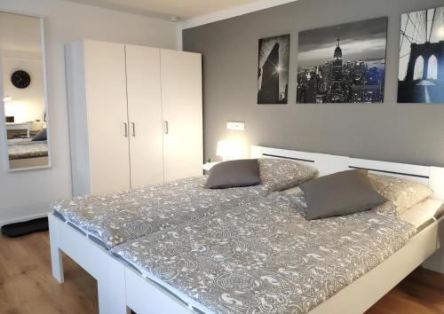 a bedroom with a large white bed with two pillows at Gemütliches Apartment mit WLAN in ruhiger Lage! in Dielmissen