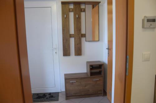 a hallway with a wooden dresser in a room at COMFY and BRIGHT Apartment in Kranj