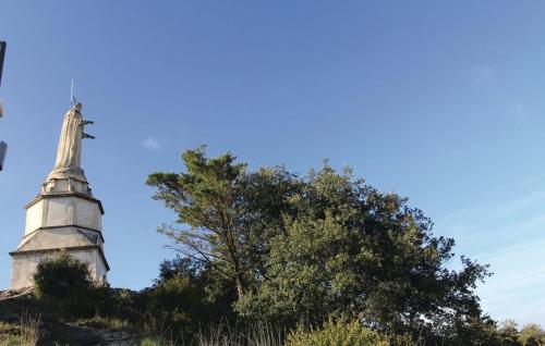 a church steeple on top of a hill with a tree at LES JARDINS DE LA CATHÉDRALE chambres d Hôtes gîte de groupe in Viviers