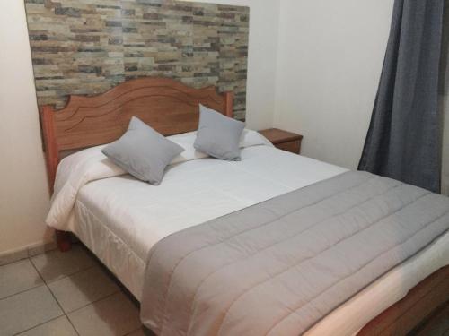 Ένα ή περισσότερα κρεβάτια σε δωμάτιο στο Hotel y Cabañas Rural Mirador del Maipo