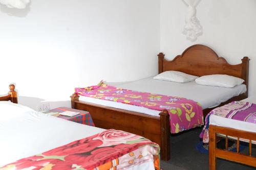a bedroom with two twin beds and two chairs at Ella Tea Land View in Ella