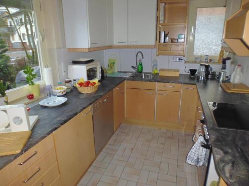 a kitchen with wooden cabinets and a counter top at Dom y Ziel in Unterflockenbach