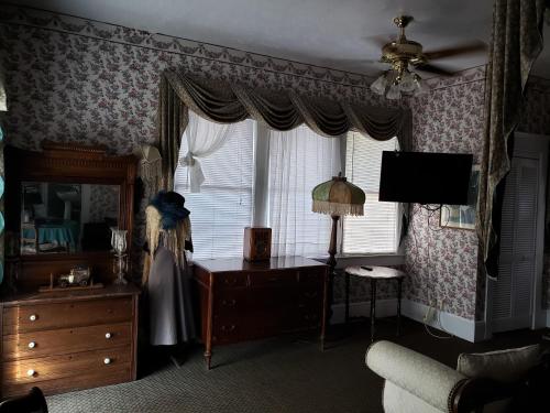 a living room with a dresser and a window at Topaz Motel - Flagler Beach in Flagler Beach