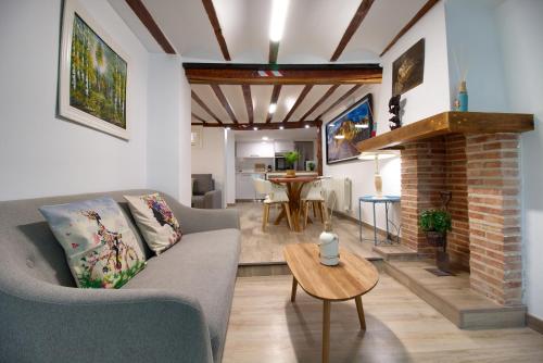 a living room with a couch and a fireplace at cuencaloft trinidad in Cuenca