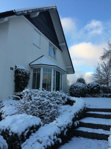 a house with a pile of snow in front of it at An den Bergwiesen in Winterberg