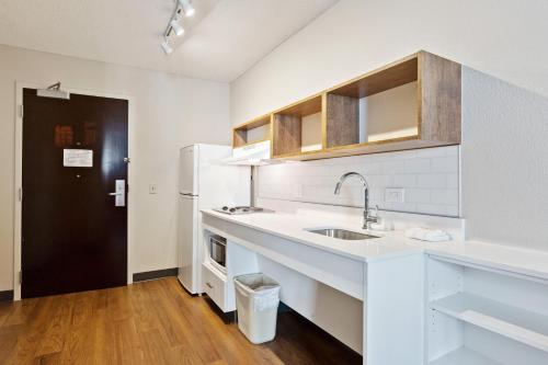 a white kitchen with a sink and a refrigerator at Extended Stay America Premier Suites - San Francisco - Belmont in Belmont