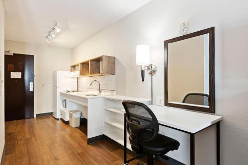 a white kitchen with a desk and a black chair at Extended Stay America Premier Suites - San Francisco - Belmont in Belmont