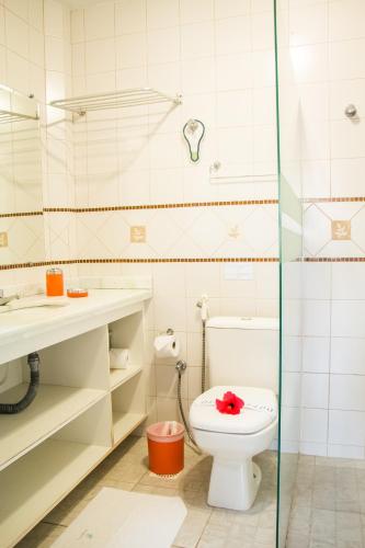 a bathroom with a toilet and a sink and a shower at Pousada Vila Boa Vida in Bombinhas