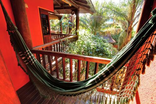 a hammock on a porch of a house at Pousada Vila Boa Vida in Bombinhas