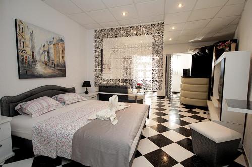 a bedroom with a bed and a checkered floor at Apartments Kruna Jovanović in Sutomore