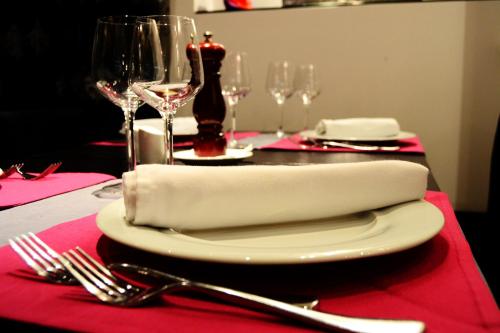 a table with a white plate with a napkin on it at Hotel Iliana in Filippiada