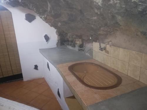 a bathroom with a sink and a bath tub at Casa cueva El perucho in Güimar
