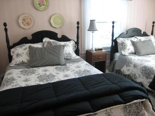 a bedroom with two beds and a window at Victoria Inn in Hampton
