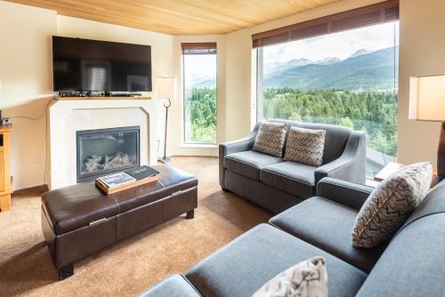 a living room with a couch and a fireplace at The Ironwood on Blueberry Hill in Whistler