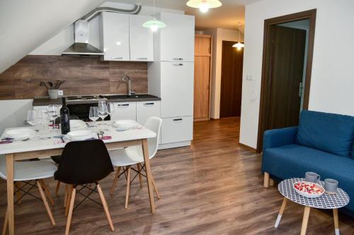 a kitchen and living room with a table and chairs at Tesla Coil Apartments in Gospić