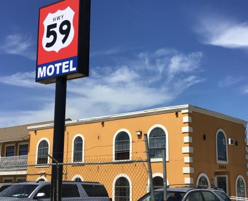 a sign for a motel in front of a building at Hwy 59 Motel Laredo Medical Center in Laredo