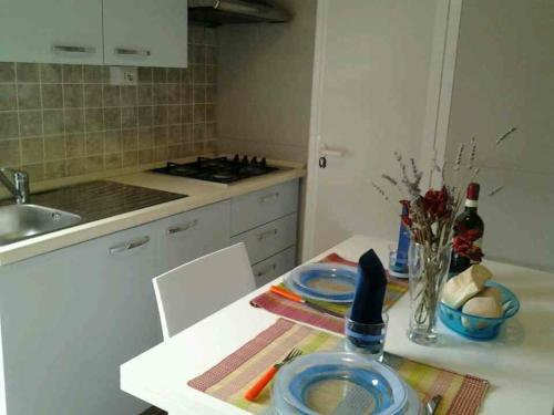 a kitchen with a table with plates on it at Campeggio Piano Grande in Baveno