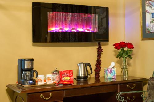 a room with a table with a coffee maker on top of a table at The Stockade Bed and Breakfast in Baton Rouge