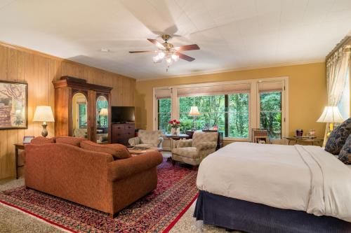 a bedroom with a bed and a living room at The Stockade Bed and Breakfast in Baton Rouge