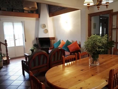 a dining room with a wooden table and chairs at Finca Artienza in Ramales de la Victoria