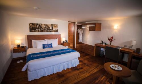 a hotel room with a bed and a desk at Aranwa Pueblito Encantado del Colca in Coporaque