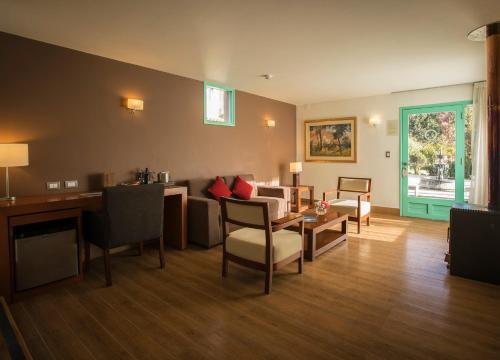 a living room with a couch and a table at Aranwa Pueblito Encantado del Colca in Coporaque