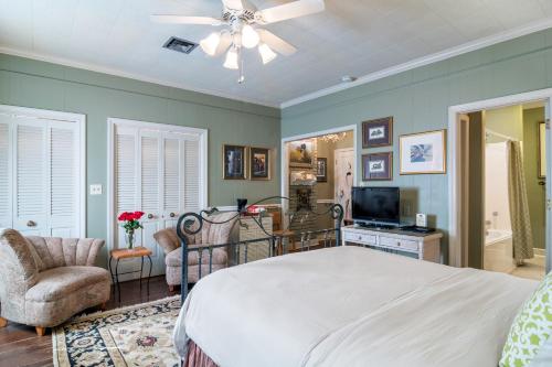 a bedroom with a large bed and a television at The Stockade Bed and Breakfast in Baton Rouge