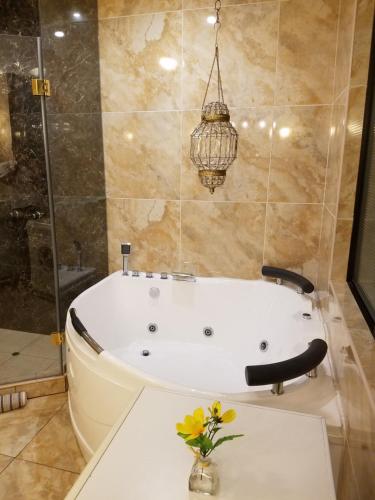 a bath tub with a vase of flowers in a bathroom at Entire Studio-Apartment De Luxe in Lima