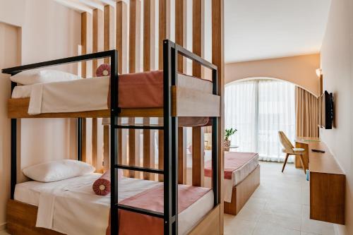 a bunk bed room with two bunk beds in it at Olivia Palm Hotel in Kyrenia