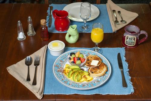 a table with a plate of breakfast food on a table at The Stockade Bed and Breakfast in Baton Rouge