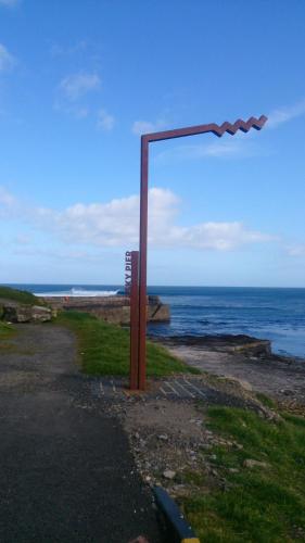 a street light on the side of a road near the ocean at Easkey Hostel in Sligo