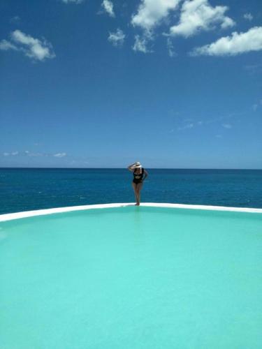 a person standing on a beach near the ocean at Habitacion en Sol Dominicus solo adultos in Bayahibe