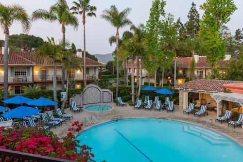 a view of the pool at the resort with chairs and umbrellas at Westlake Village Inn in Westlake Village