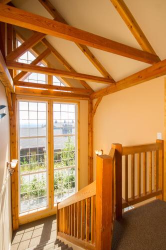 a room with a wooden staircase and a large window at 3 BR 3 Bath ski in ski out with private hot tub in Big White
