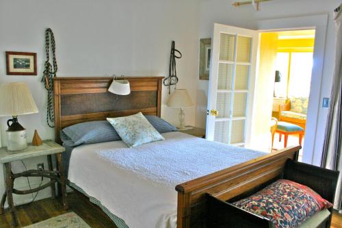 a bedroom with a bed and a table with a lamp at Old Pioneer Garden Country Inn in Unionville