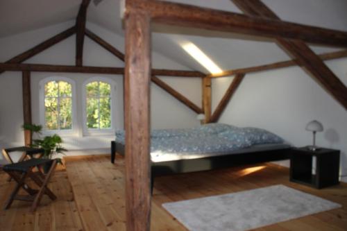 a bedroom with a bed in a room with wooden beams at Ferienwohnung Goldgrund Gartenblick in Meißen