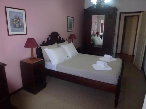 a bedroom with a large bed and a mirror at Home of pilgrims d`Apúlia in Apúlia
