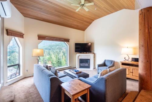 a living room with a couch and chairs and a fireplace at The Ironwood on Blueberry Hill in Whistler