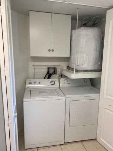 a white kitchen with a stove and a washer at 2 Bedroom , 2 Bath , Villa in Oldsmar