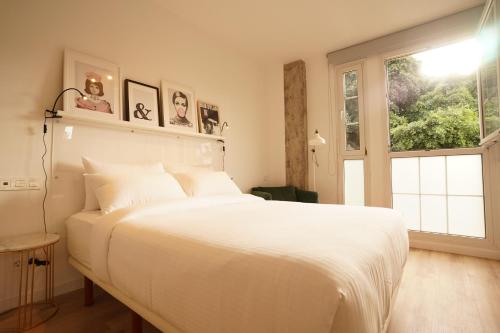 a bedroom with a large white bed and a window at THE STAY Las Palmas VV in Las Palmas de Gran Canaria