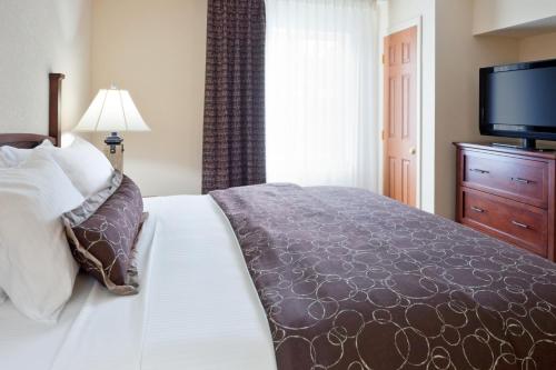 a bedroom with a bed and a flat screen tv at Staybridge Suites - Philadelphia Valley Forge 422 by IHG in Royersford