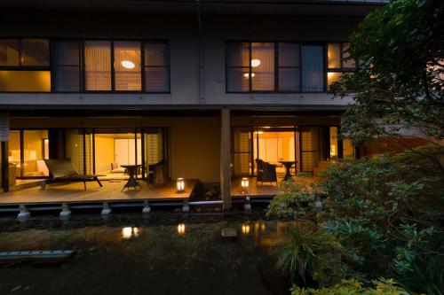 a building with a pool in front of it at night at Oku Yugawara Tsubaki in Yugawara